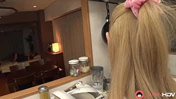 A Japanese homemaker gives oral pleasure to a man in the kitchen without censorship